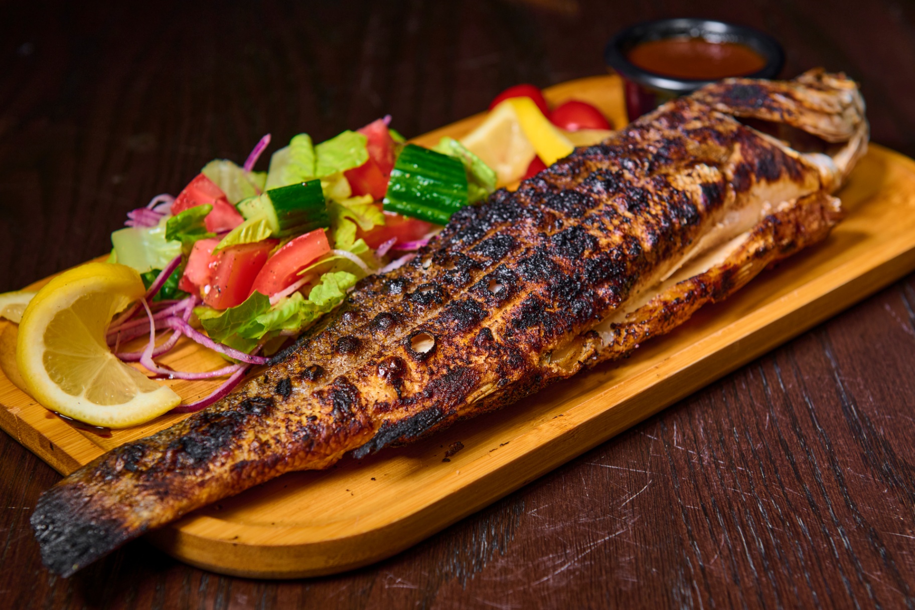Whole grilled Branzino seafood plate at Platinum Mic Brooklyn karaoke lounge